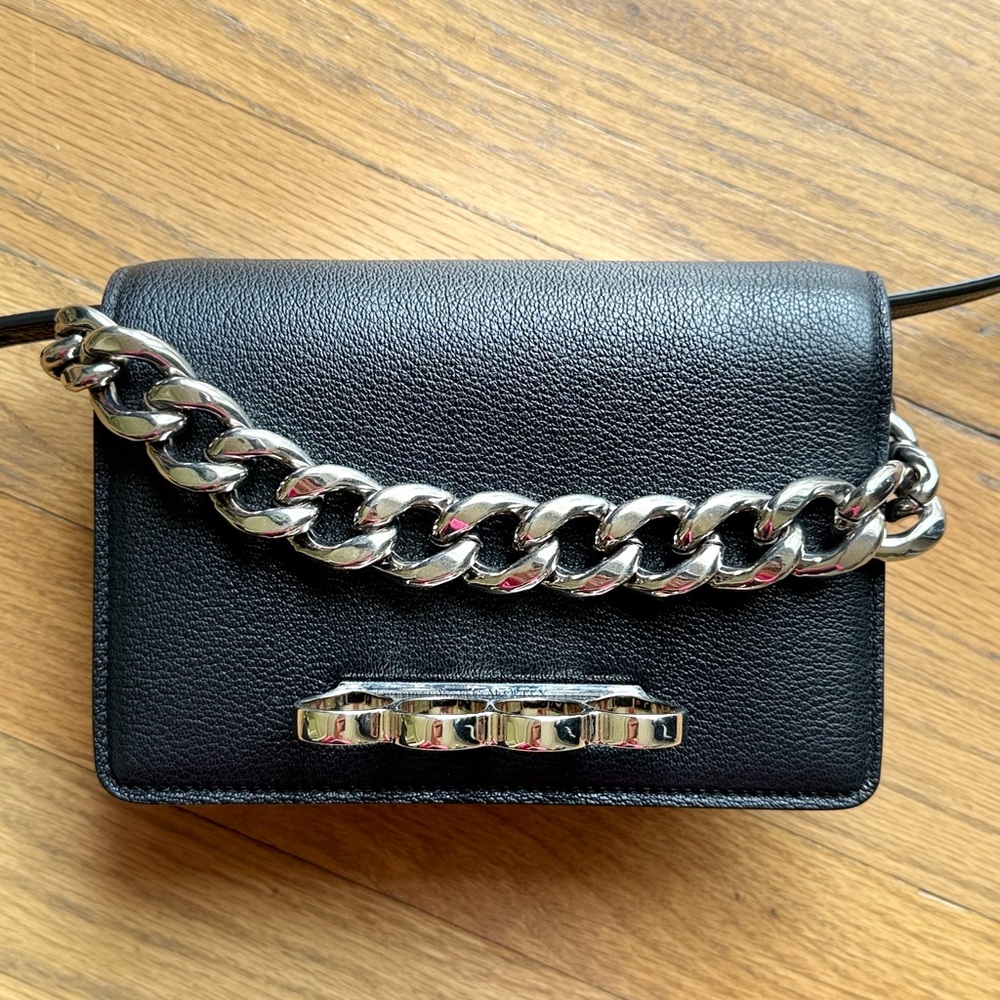 Alexander McQueen Four-ring black leather mini Crossbody Bag.